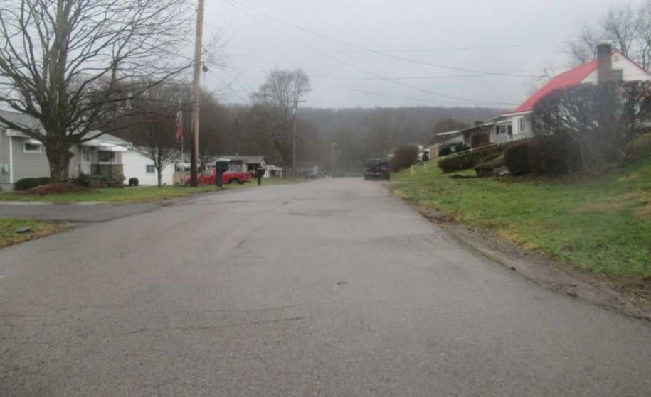 1421 Davidson Street Wampum, PA 16157 - Photo 2 of 3 a view of a street with a building in the background