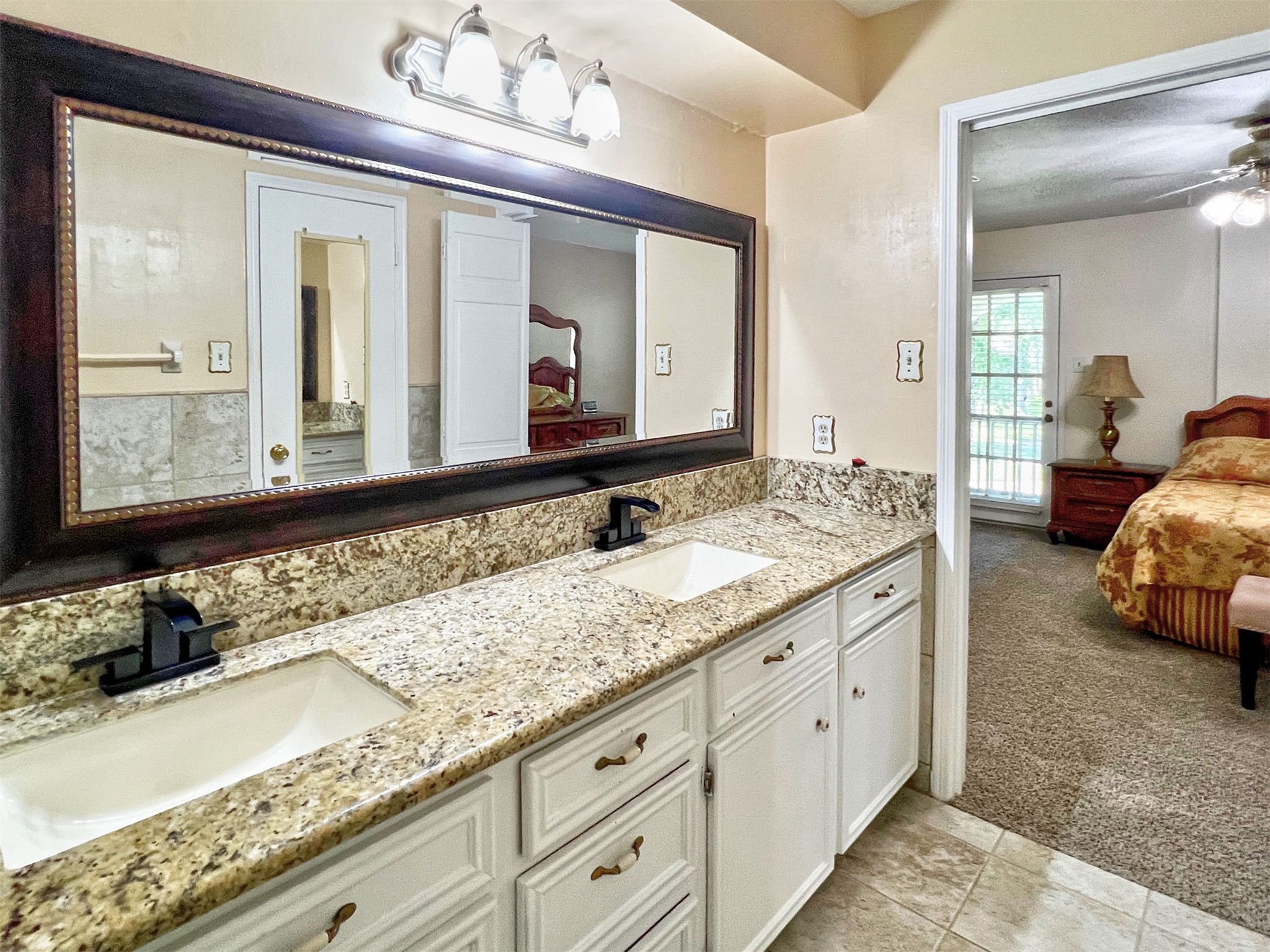 16902 Summit Oaks Lane Spring, TX 77379 - Photo 31 of 49 a en suite bathroom with double sink and a mirror