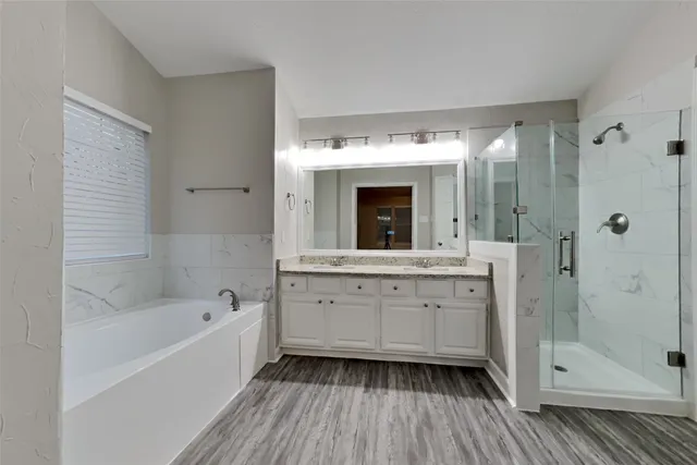a bathroom with a sink a mirror and a bathtub