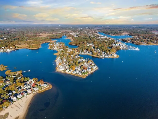 an aerial view of a house with a ocean view