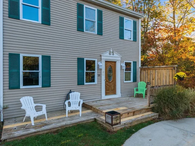 a backyard of a house with table and chairs