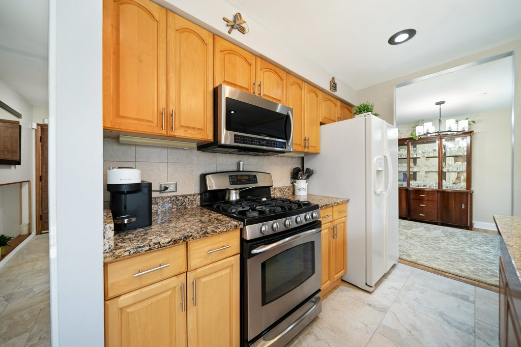 365 West Myrick Avenue Addison, IL 60101 - Photo 11 of 49 a kitchen with stainless steel appliances granite countertop a stove top oven a refrigerator and a sink