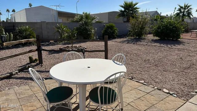 a view of a patio with table and chairs potted plants with wooden floor