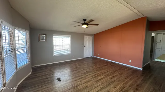 a kitchen with granite countertop a sink a stove and a refrigerator