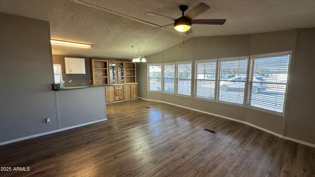 an empty room with wooden floor and closet