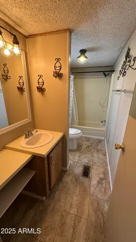 a view of a room with wooden floor and brick wall