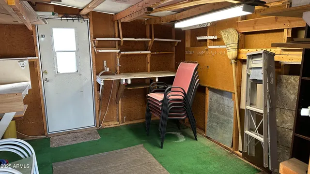 a backyard of a house with barbeque oven table and chairs