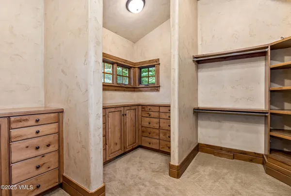 a bathroom with a granite countertop tub sink and mirror