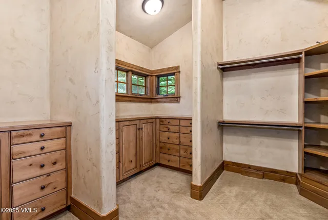 a bathroom with a granite countertop tub sink and mirror