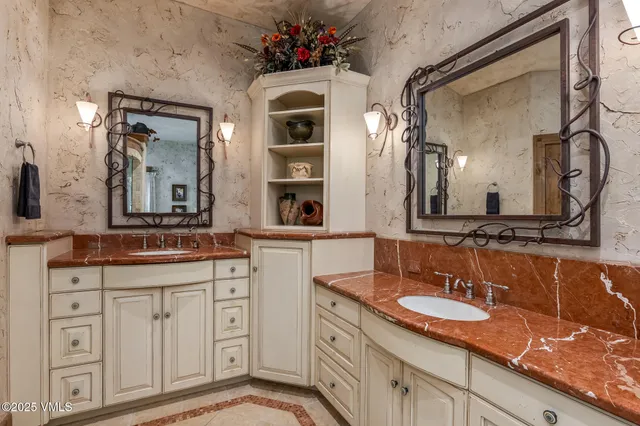 a bedroom with a bed mirror and window