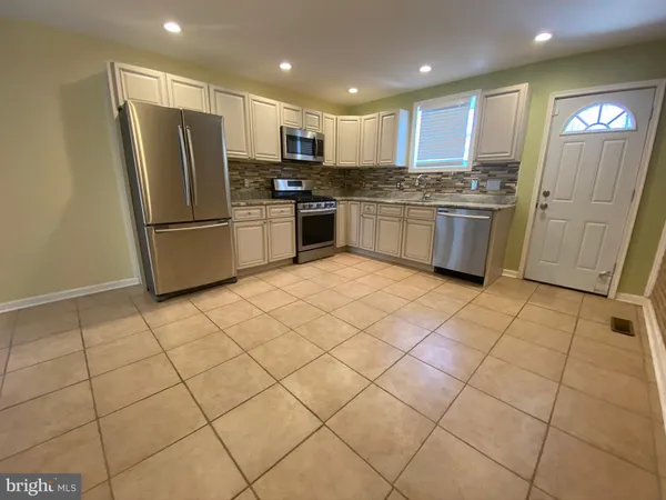 a kitchen with stainless steel appliances granite countertop a refrigerator sink and cabinets