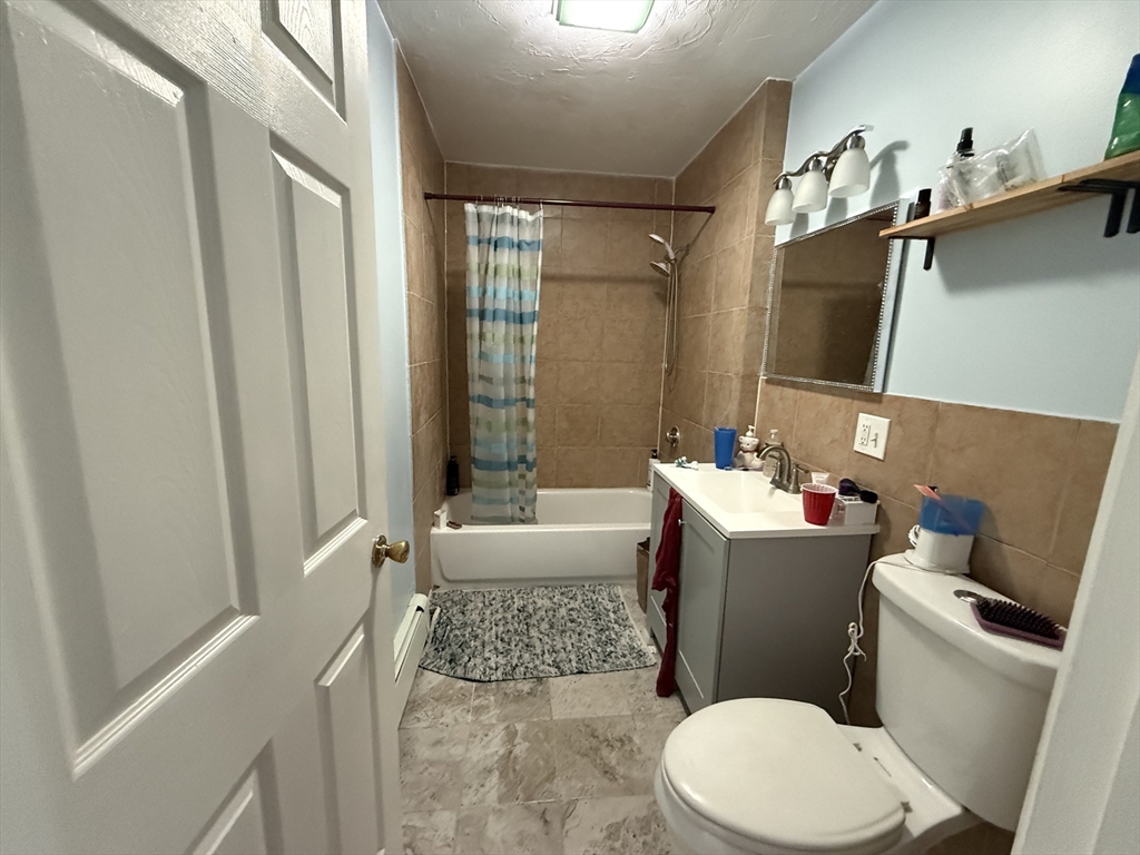 55 Lithgow Street, Unit 3 Boston, MA 02124 - Photo 11 of 16 a bathroom with a sink toilet and shower