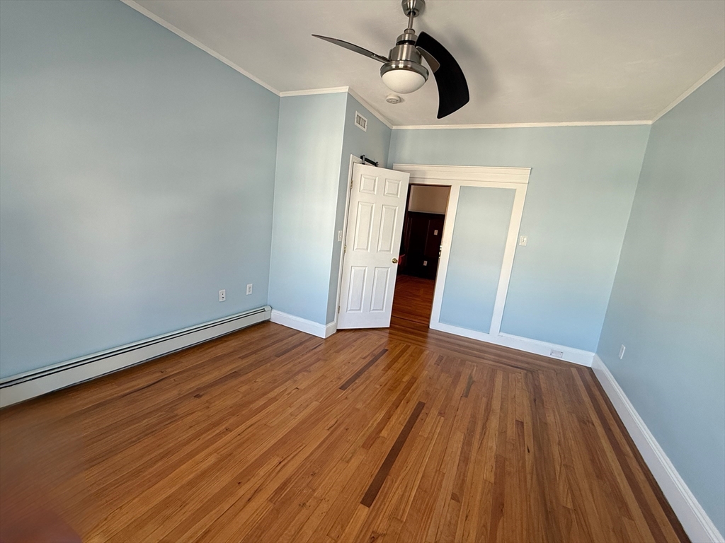 55 Lithgow Street, Unit 3 Boston, MA 02124 - Photo 16 of 16 a view of empty room with wooden floor