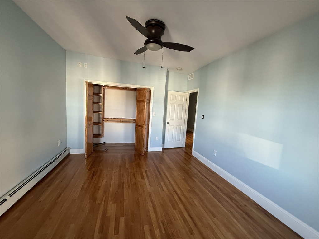 55 Lithgow Street, Unit 3 Boston, MA 02124 - Photo 5 of 16 a view of empty room with wooden floor and window