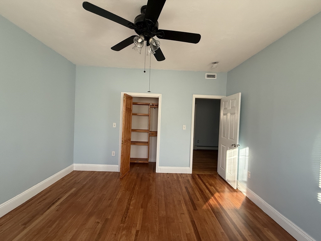 55 Lithgow Street, Unit 3 Boston, MA 02124 - Photo 6 of 16 a view of empty room with wooden floor