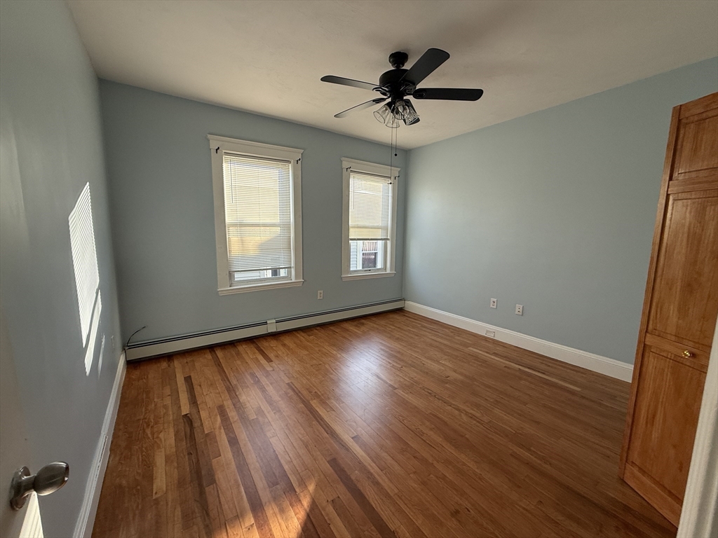 55 Lithgow Street, Unit 3 Boston, MA 02124 - Photo 7 of 16 a view of empty room with wooden floor and fan