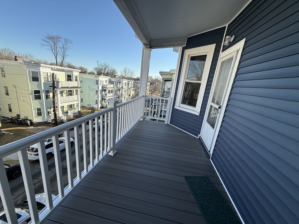 55 Lithgow Street, Unit 3 Boston, MA 02124 - Photo 8 of 16 a view of a balcony with wooden floor