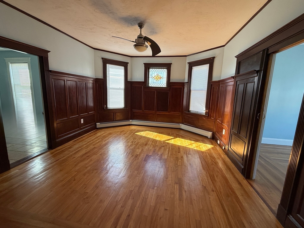 55 Lithgow Street, Unit 3 Boston, MA 02124 - Photo 10 of 16 a view of empty room with wooden floor and fan