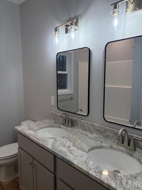 5461 Bear Creek Road Rustburg, VA 24588 - Photo 19 of 27 a bathroom with double vanity sinks and a mirror