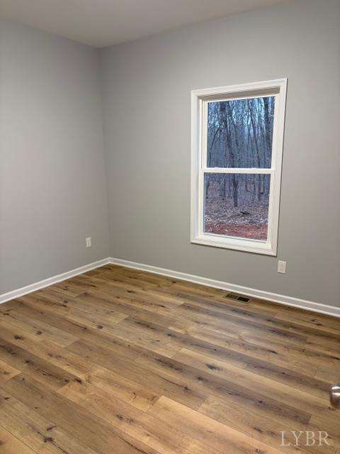 5461 Bear Creek Road Rustburg, VA 24588 - Photo 21 of 27 a view of an empty room with wooden floor and a window