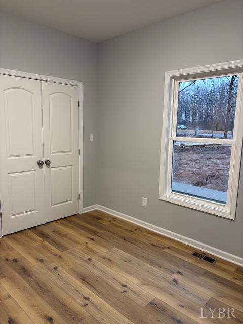 5461 Bear Creek Road Rustburg, VA 24588 - Photo 22 of 27 a view of an empty room with wooden floor and a window