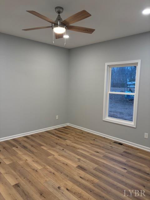 5461 Bear Creek Road Rustburg, VA 24588 - Photo 23 of 27 en empty room with wooden floor chandelier fan and windows