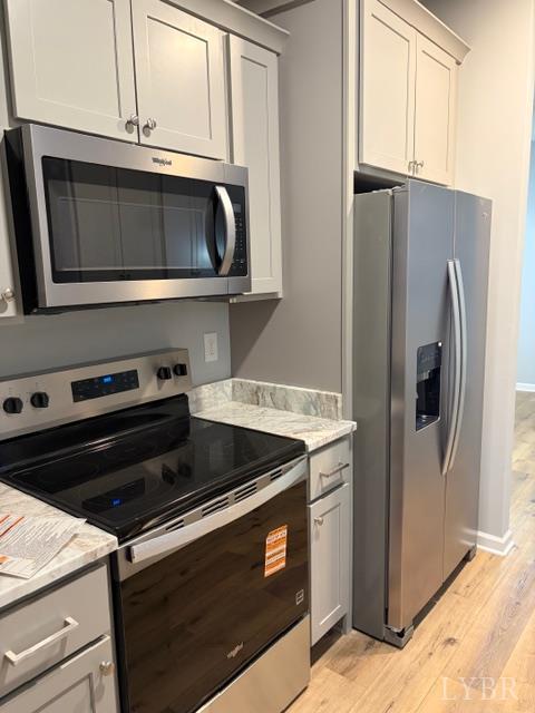 5461 Bear Creek Road Rustburg, VA 24588 - Photo 7 of 27 a kitchen with stainless steel appliances granite countertop a stove microwave and refrigerator