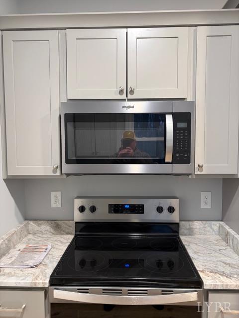 5461 Bear Creek Road Rustburg, VA 24588 - Photo 8 of 27 a kitchen with granite countertop a stove microwave and sink