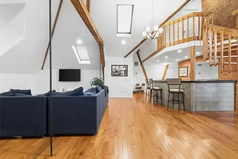 a living room with furniture and flat screen tv