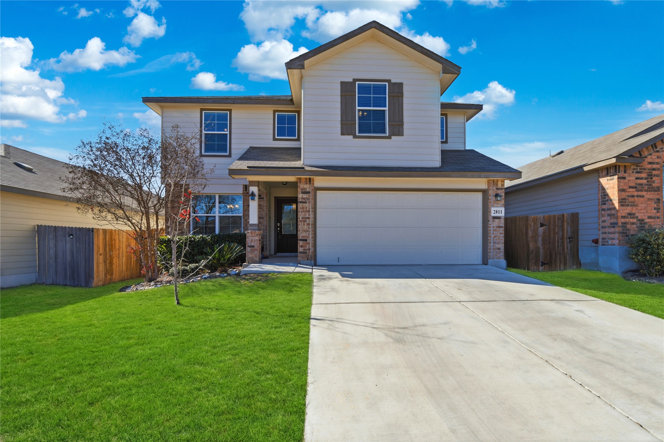 a front view of a house with a yard and garage