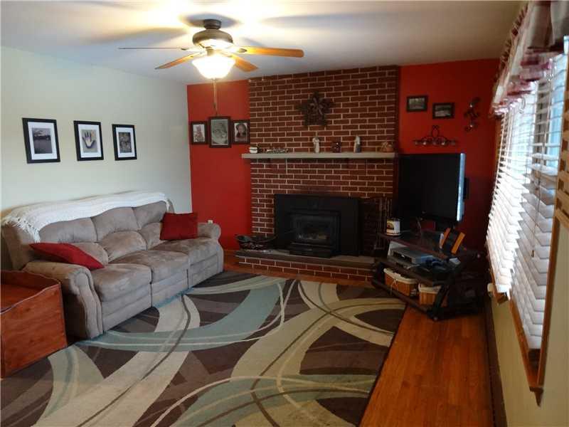 1057 Mercer Road Beaver Falls, PA 15010 - Photo 3 of 20 Family Room. Hardwood Floors and Inviting Fireplace welcome you to to be at home.