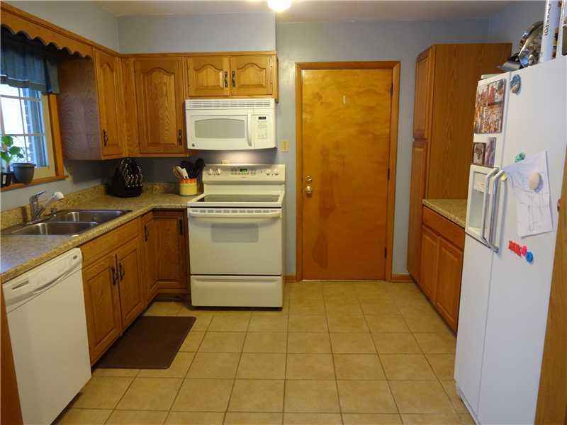 1057 Mercer Road Beaver Falls, PA 15010 - Photo 6 of 20 Kitchen. Updated Cabinetry, Counter Tops & Ceramic Flooring in Spacious Kitchen with Newer Appliances. Door to Garage.