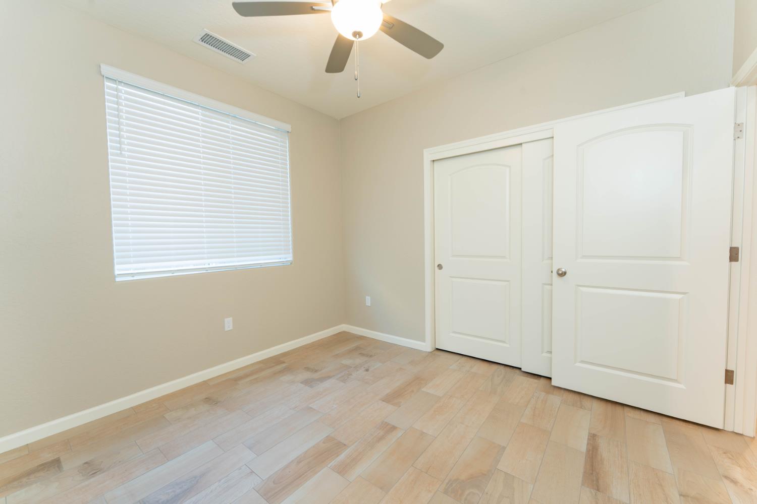 30480 Bellwood Road Visalia, CA 93291 - Photo 30 of 37 an empty room with a window and a ceiling fan