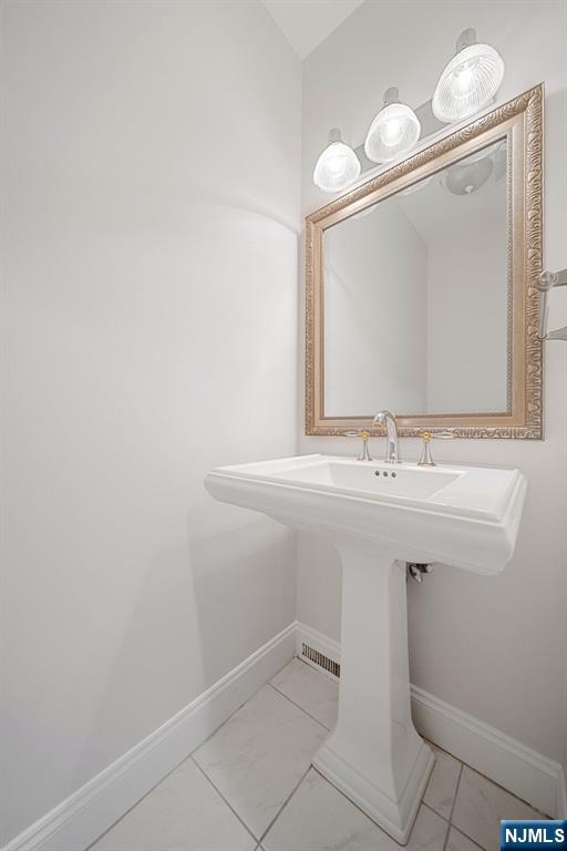 12 Sandburg Court Mahwah, NJ 07430 - Photo 15 of 33 a bathroom with a sink and a mirror