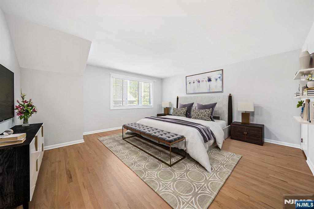 12 Sandburg Court Mahwah, NJ 07430 - Photo 16 of 33 a bedroom with a bed and wooden floor