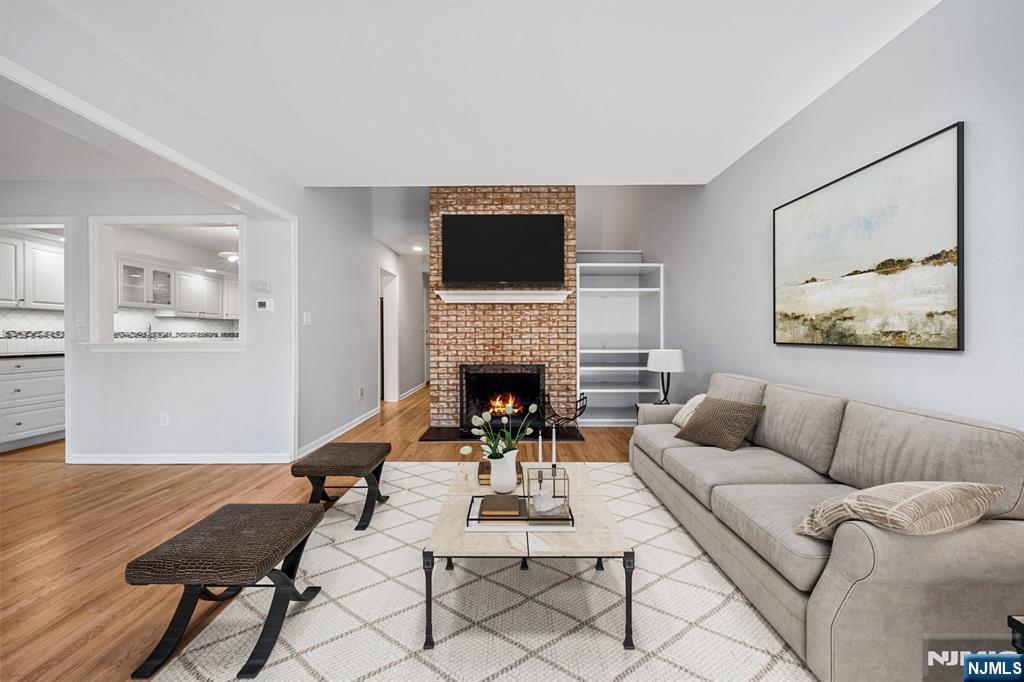 12 Sandburg Court Mahwah, NJ 07430 - Photo 6 of 33 a living room with furniture a flat screen tv and a fireplace