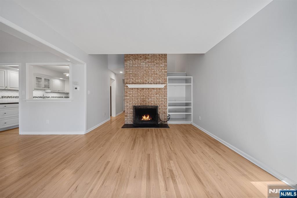 12 Sandburg Court Mahwah, NJ 07430 - Photo 7 of 33 a view of an empty room with wooden floor fireplace and a window