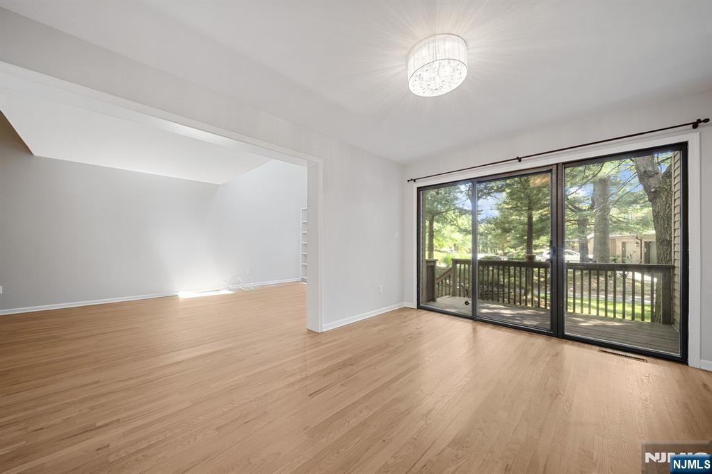 12 Sandburg Court Mahwah, NJ 07430 - Photo 9 of 33 a view of an empty room with wooden floor and a window
