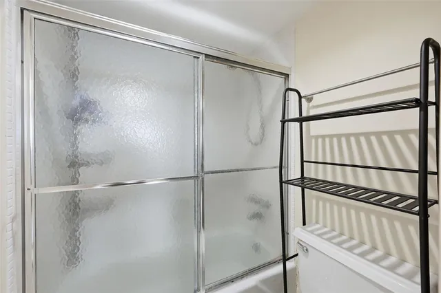 a bathroom with a glass shower door