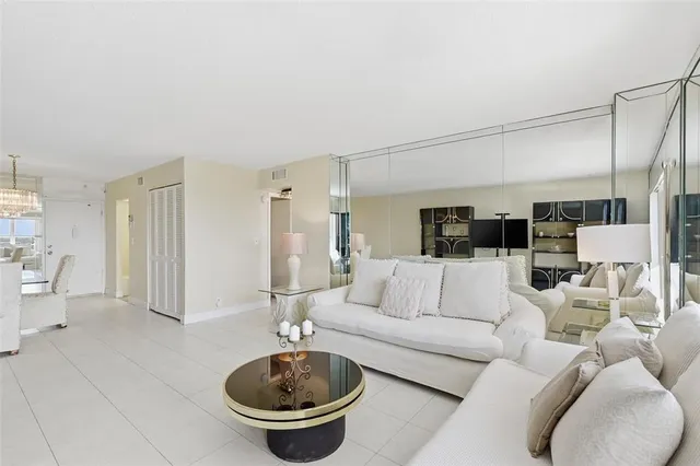 a living room with furniture and a view of bathroom