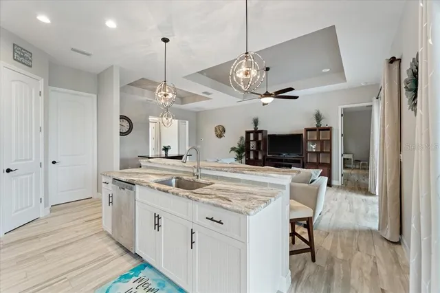 a living room with furniture a chandelier and a table