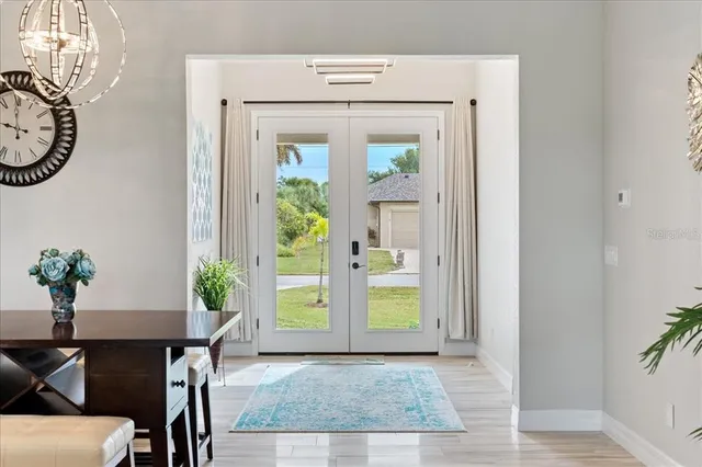 a bedroom with a large bed and a chandelier