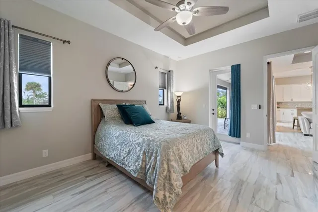 a spacious bedroom with a bed and a chandelier