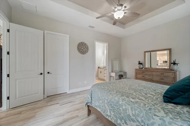 a bathroom with a granite countertop sink a potted plant and a mirror