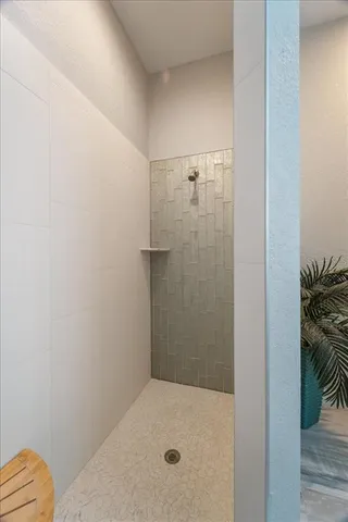 a view of a room with a bed and wooden floor