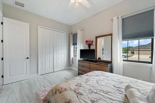 a view of swimming pool with a lounge chairs in patio