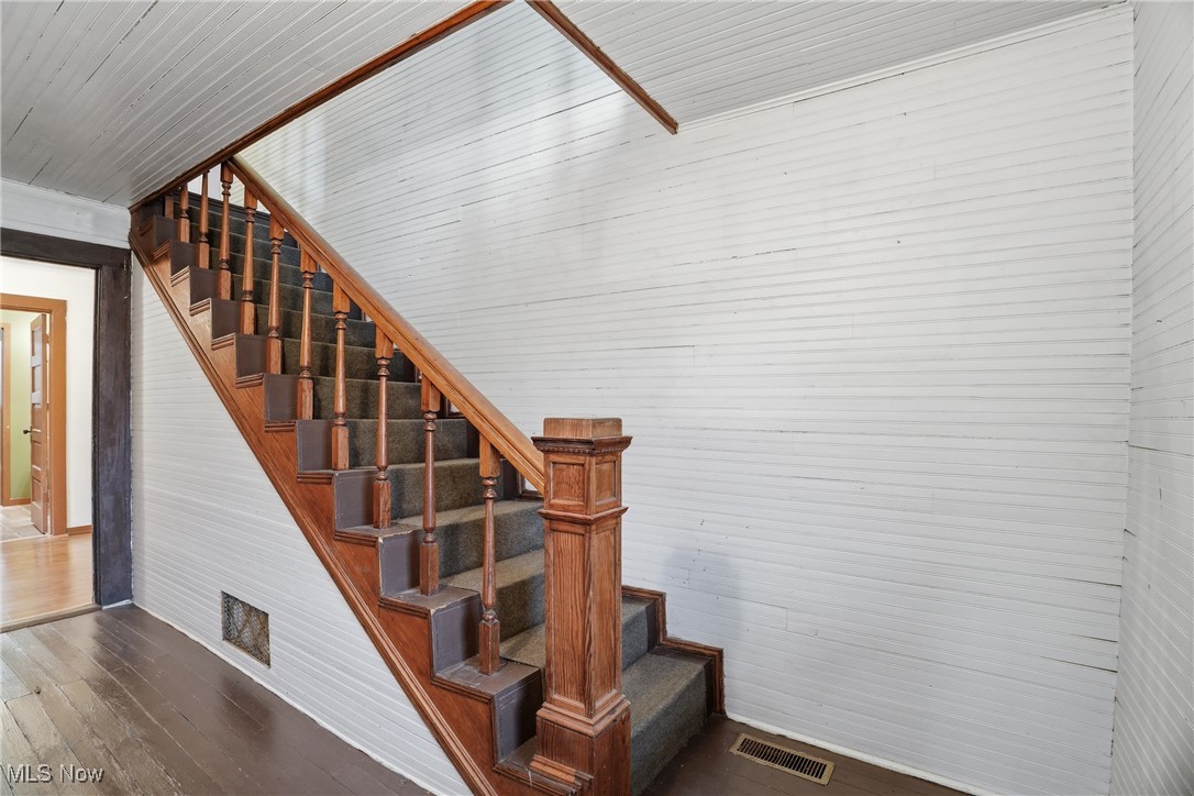 8045 Veto Road Belpre, OH 45714 - Photo 25 of 50 Stairs featuring hardwood / wood-style floors and wooden walls