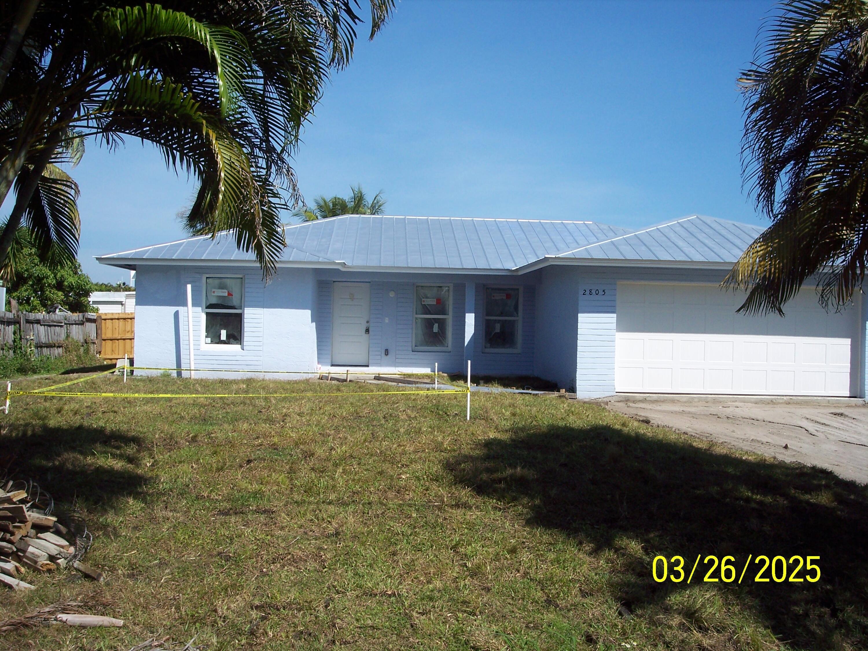 2805 Southeast Carroll Street Stuart, FL 34997 - Photo 1 of 10 a front view of a house with a garden