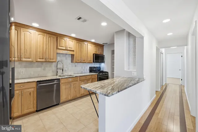 a kitchen with a sink stove and cabinets
