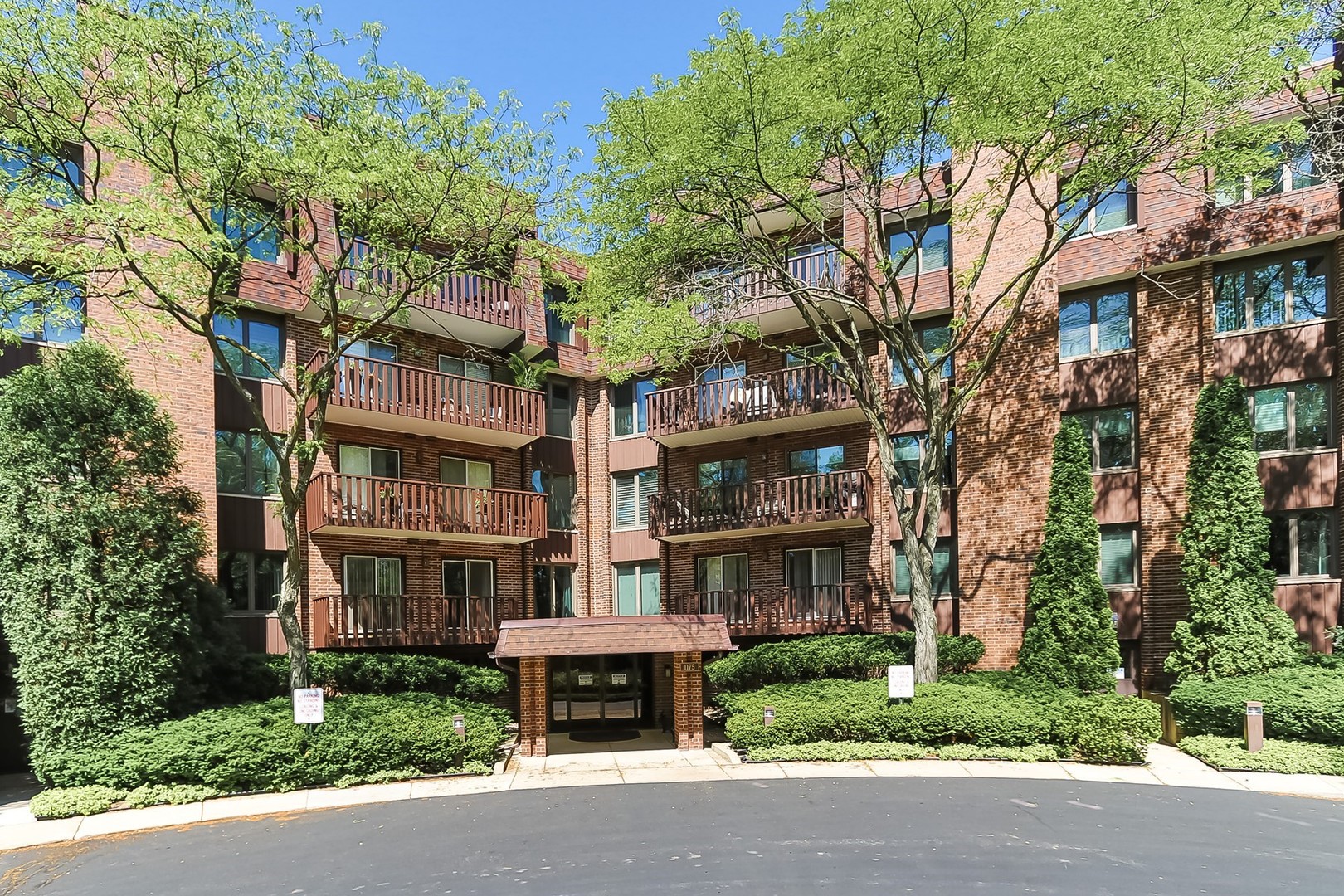 1175 Lake Cook Road, Unit 409 Northbrook, IL 60062 - Photo 1 of 27 a front view of a building with garden